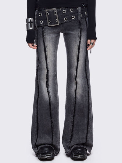 Grey flared jeans with light grey overdye featuring a chunky buckle belt and distressed seams details.