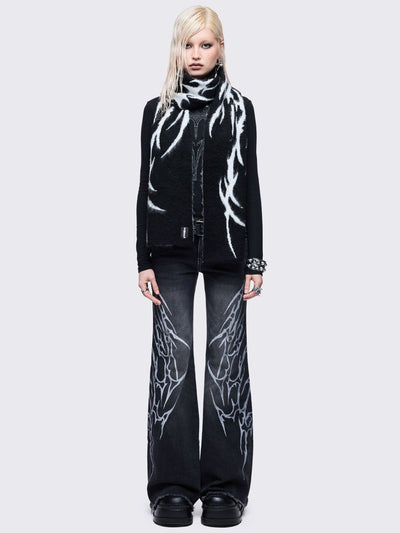 ong, chunky, and fluffy scarf featuring a high-contrast diffused tribal sigil pattern in black and grey