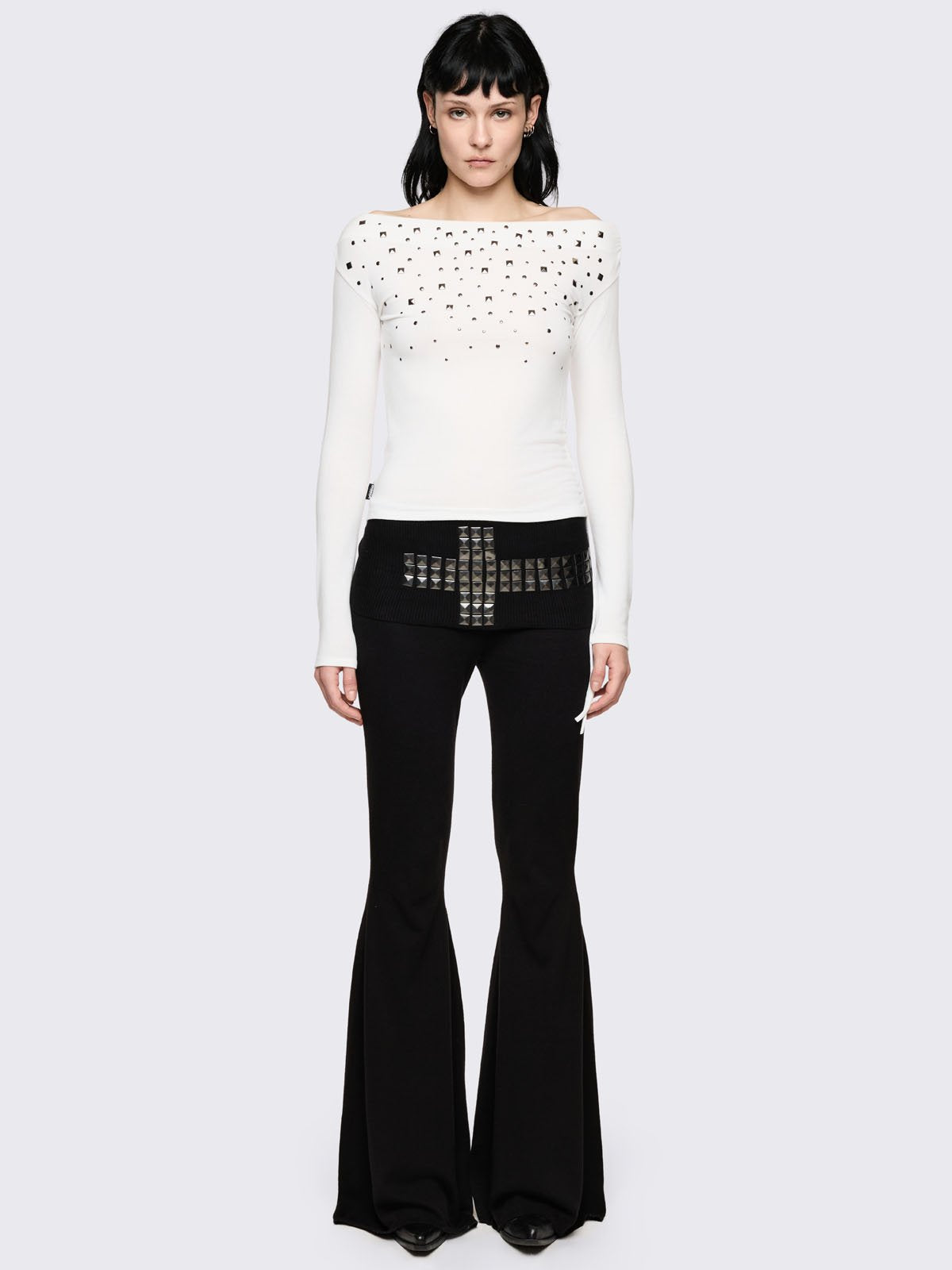 Black flare pants with folded ribbed waistband with studded cross