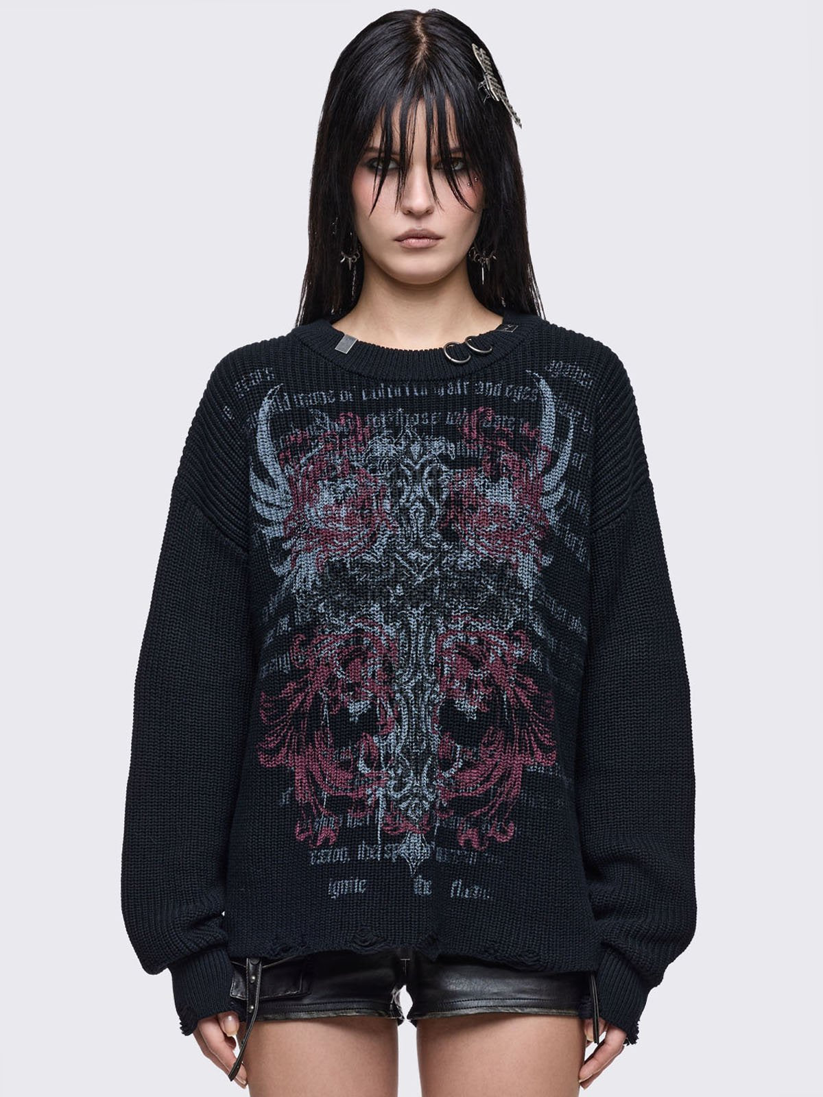 Black knitted distressed jumper with grunge graphic design and stud and O-ring details.