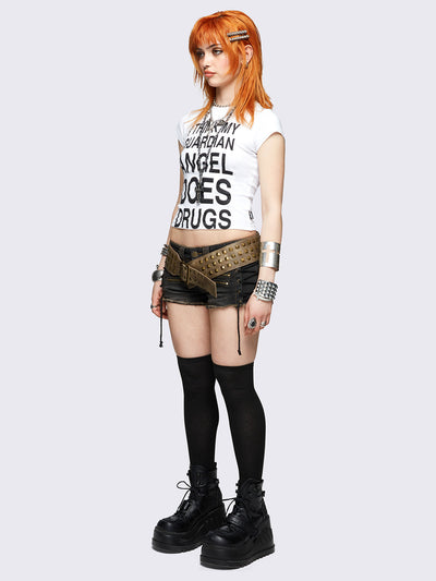 White baby tee with bold black "I think my guardian angel does drugs" front print, featuring a black cross back print.