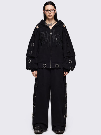 Black layered zip up hoodie, with chunky silver eyelets, raw edge seam details and Minga embroidery.