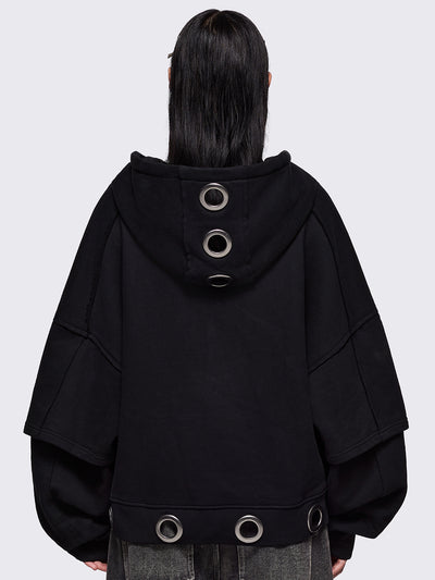 Black layered zip up hoodie, with chunky silver eyelets, raw edge seam details and Minga embroidery.