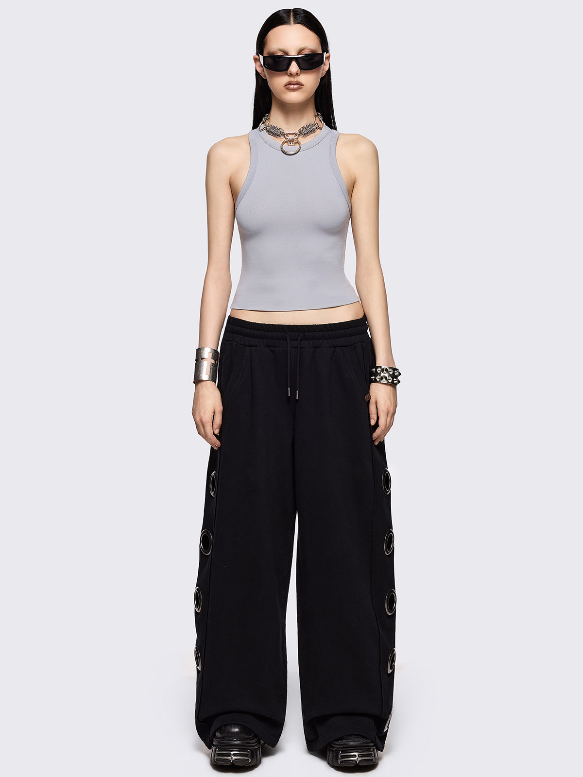 Black wide leg sweatpants with chunky silver eyelets.