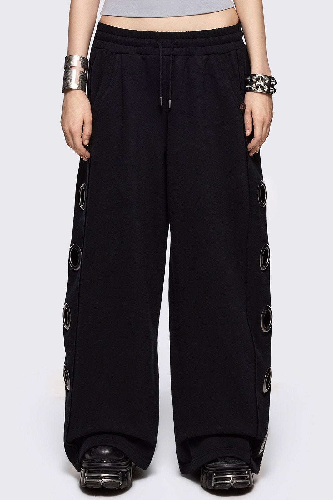 Black wide leg sweatpants with chunky silver eyelets.