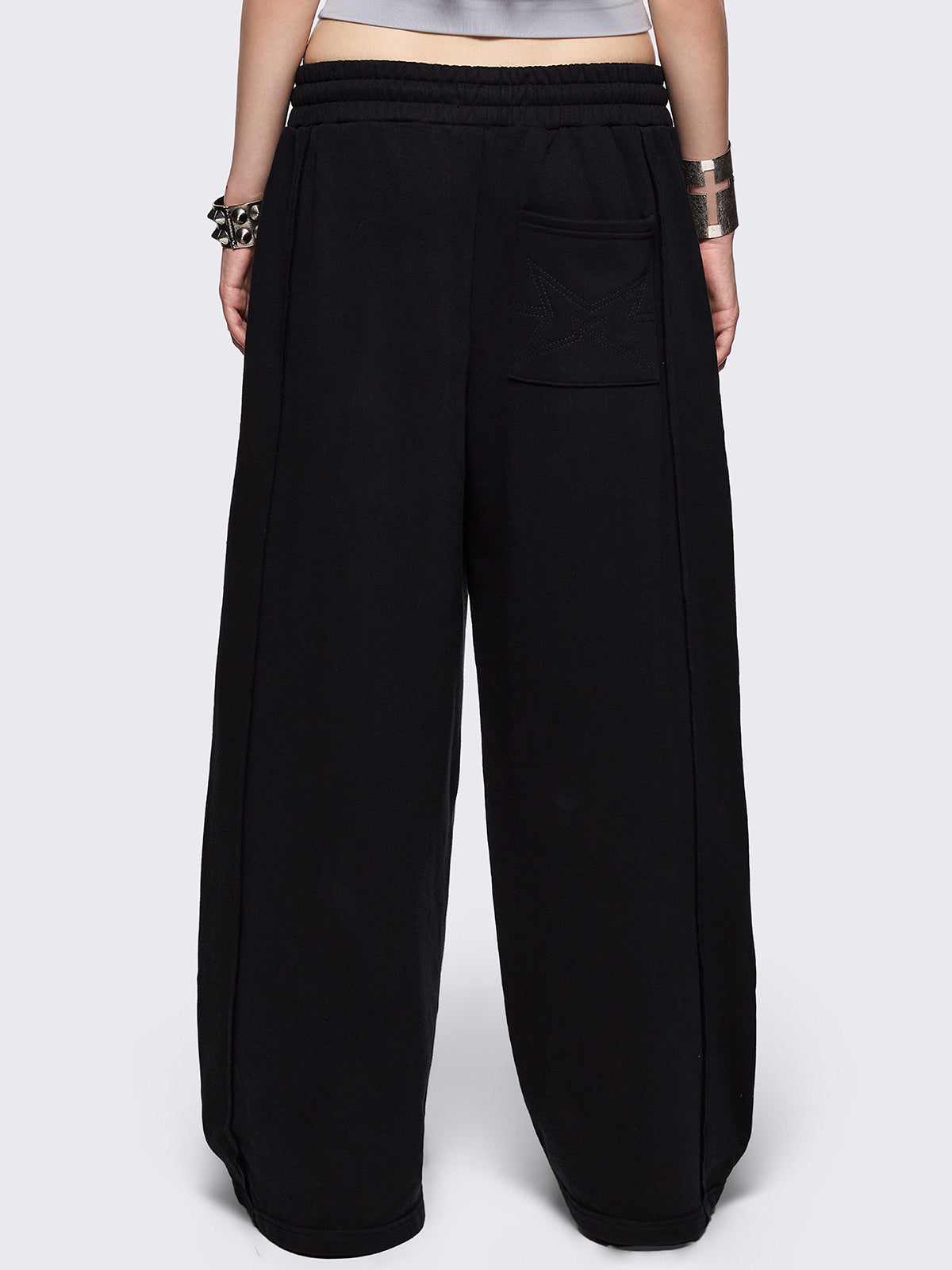 Black wide leg sweatpants with chunky silver eyelets.