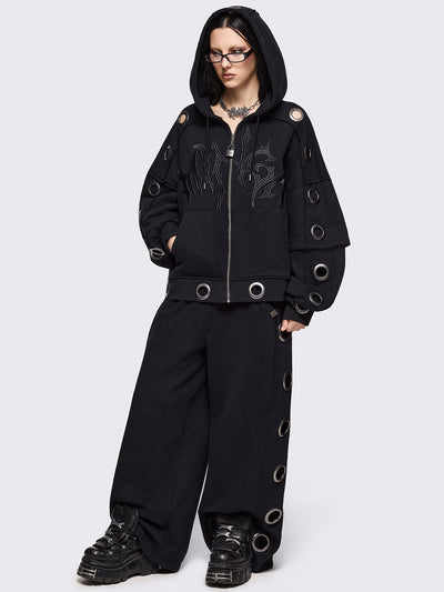 Black wide leg sweatpants with chunky silver eyelets.