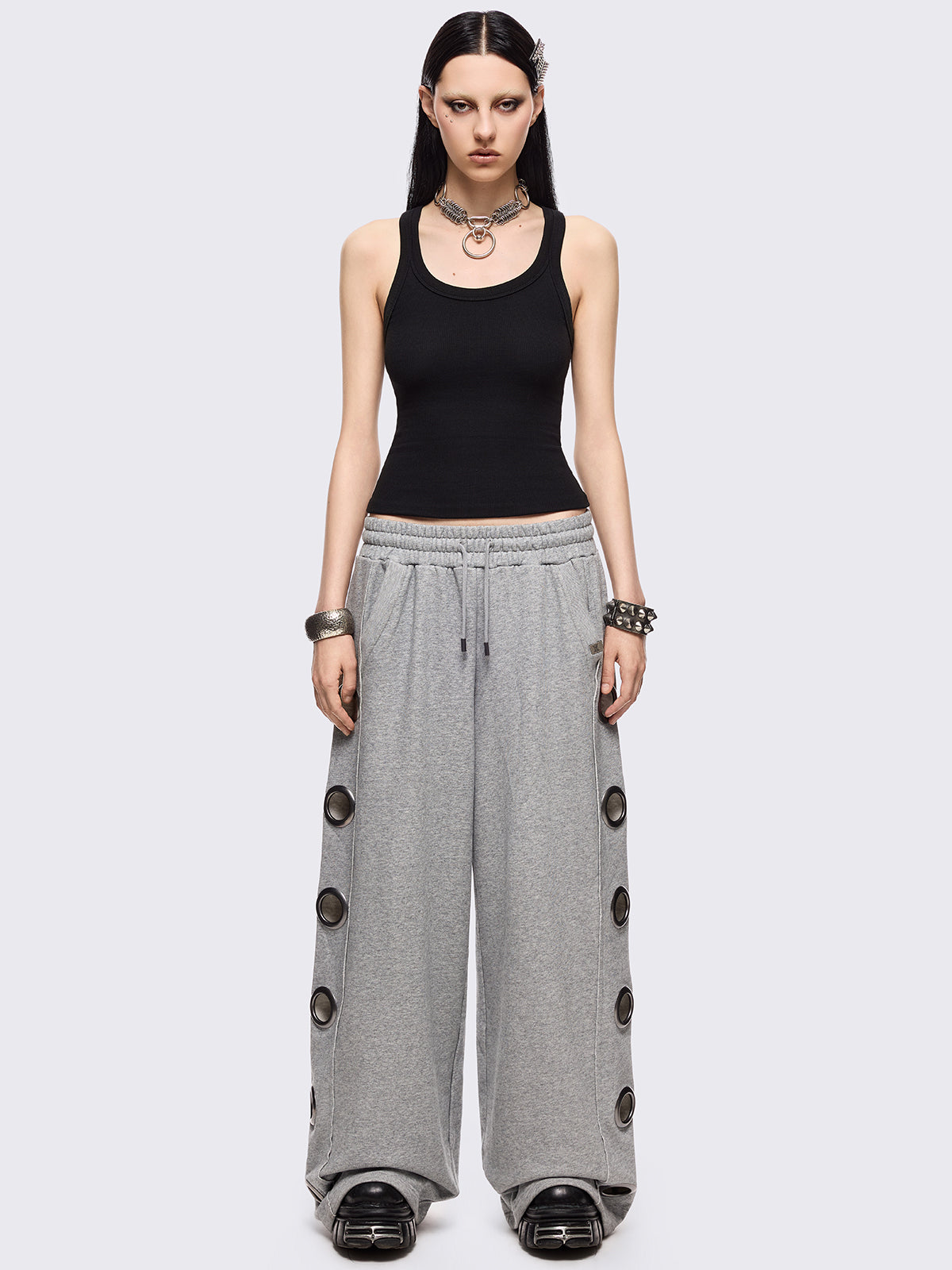 Grey marl wide leg sweatpants with chunky silver eyelets.