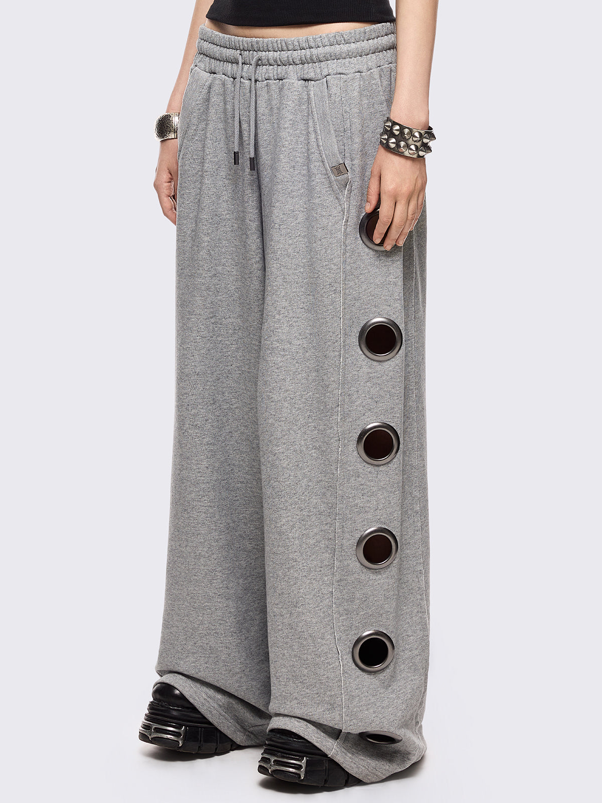 Grey marl wide leg sweatpants with chunky silver eyelets.