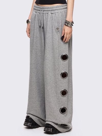 Grey marl wide leg sweatpants with chunky silver eyelets.