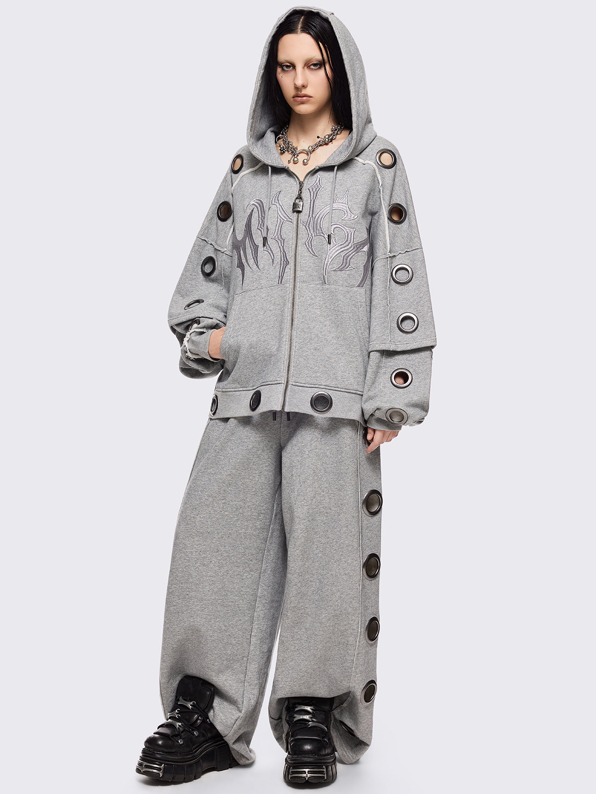 Grey marl wide leg sweatpants with chunky silver eyelets.