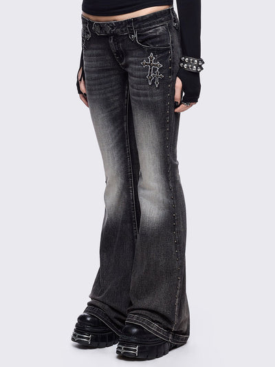 Black washed flared jeans featuring wings back and cross front embroideries and stud trim and details