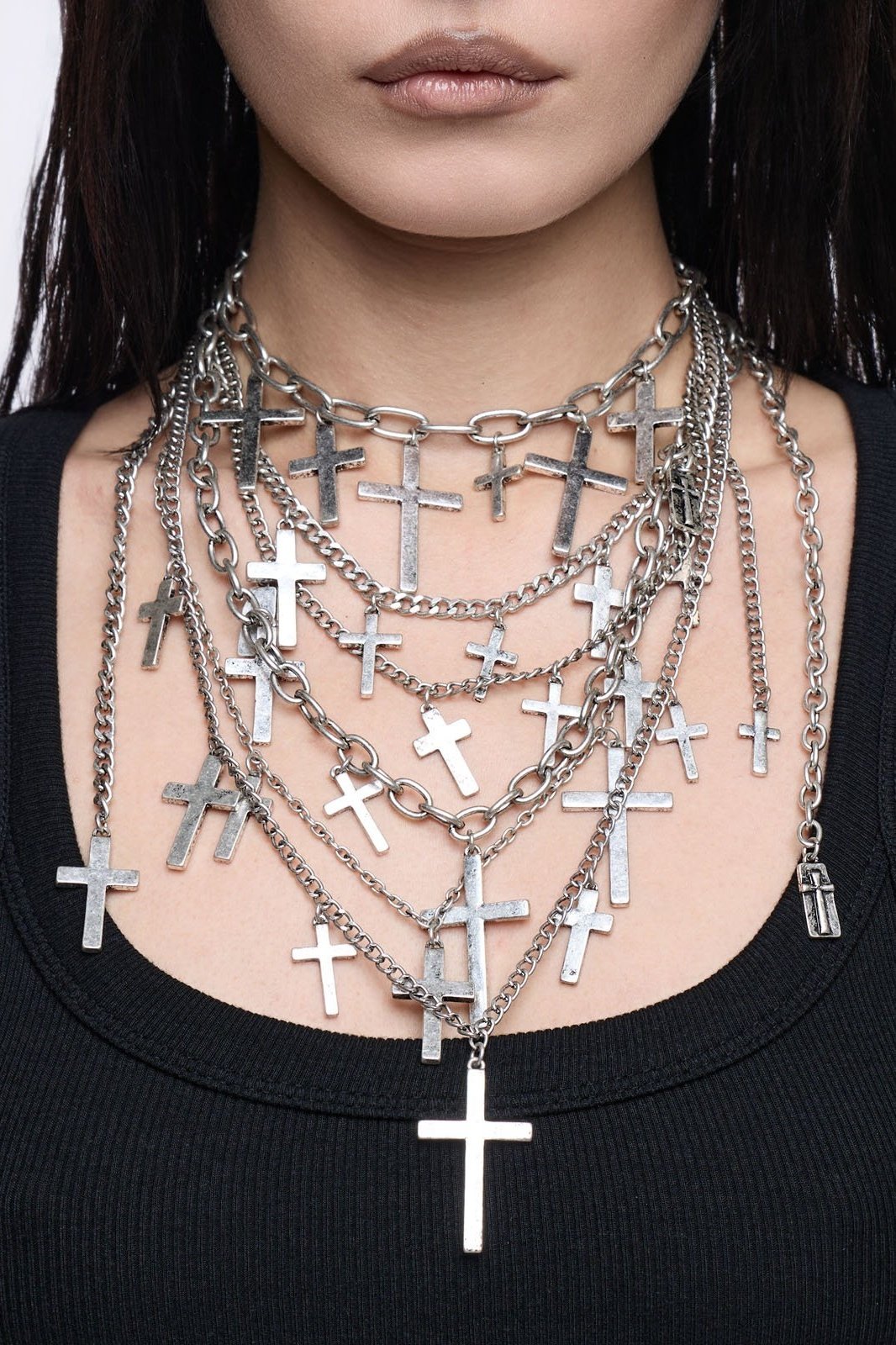 Silver multi-layered chain necklace with cross pendants.