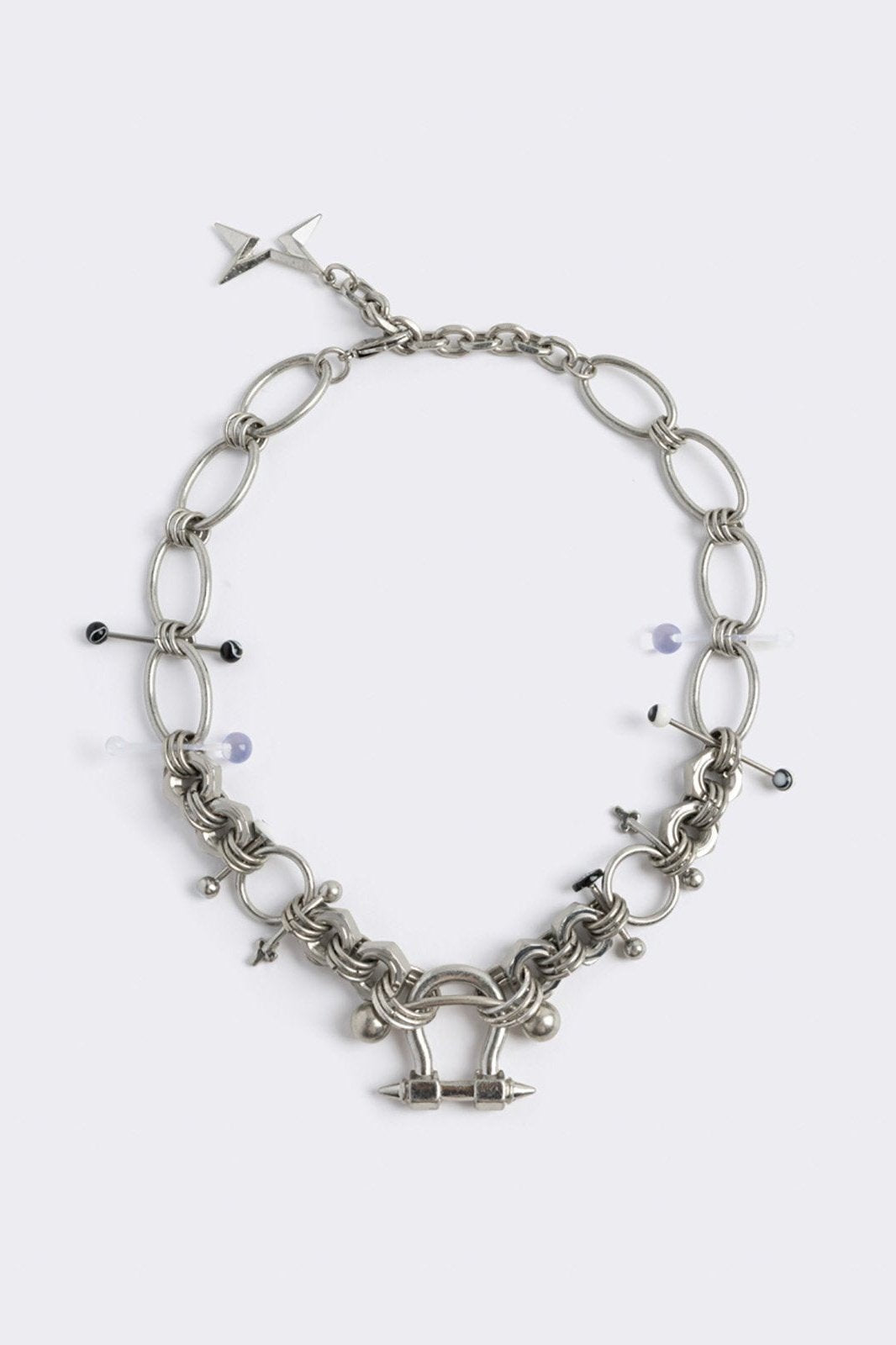 Chunky silver necklace with piercing and industrial details. 