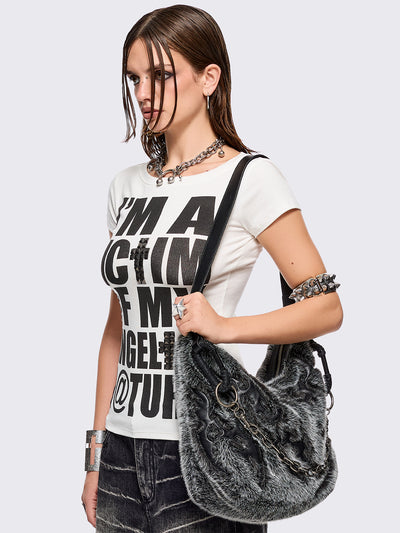 Black and grey faux fur shoulder bag with sigilism patches and silver chain detail.