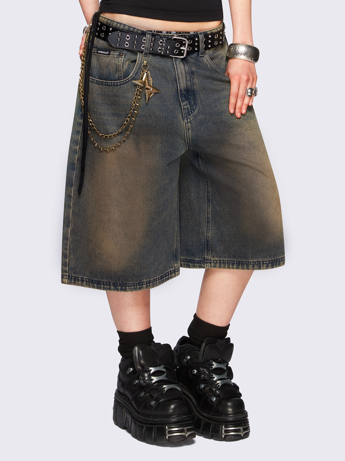 Blue washed longline denim jorts featuring a green overdye, removable chain, wide-leg fit and knee-length cut.