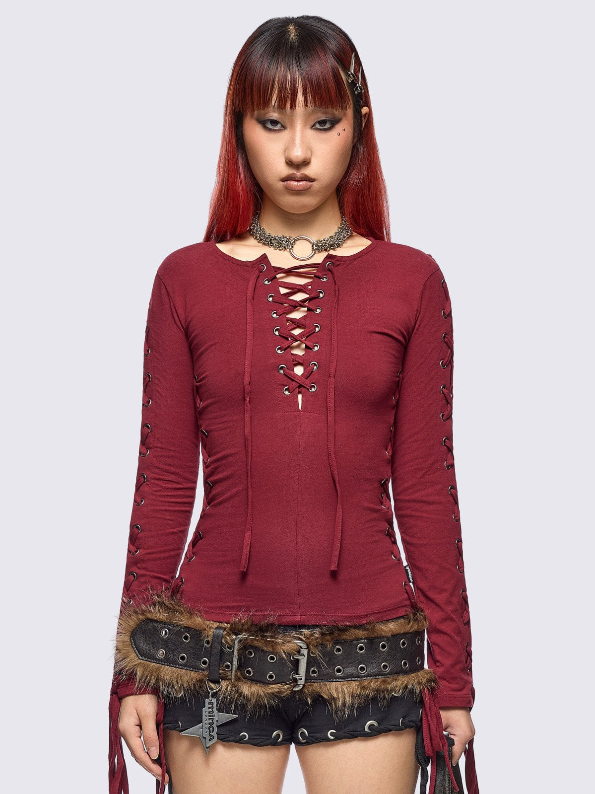 Burgundy long sleeve top with lace-up details.