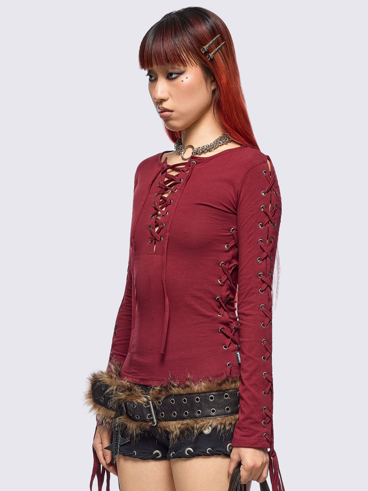 Burgundy long sleeve top with lace-up details.