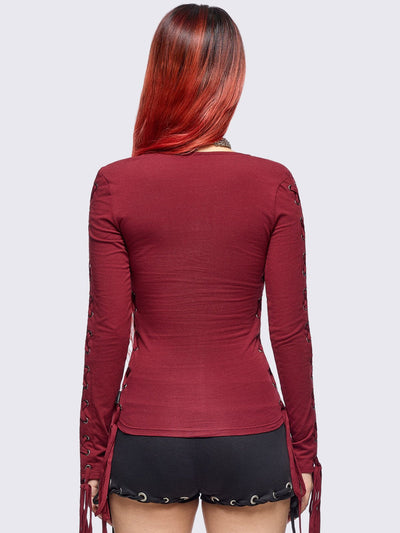 Burgundy long sleeve top with lace-up details.