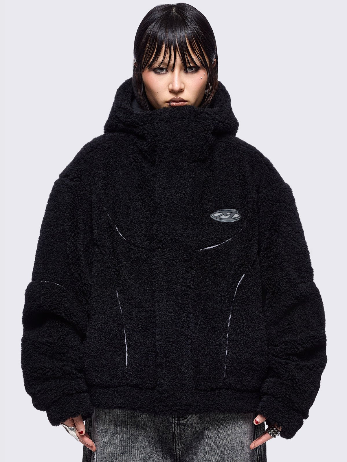 Black fleece hoodie jacket featuring grey piping and high neck hood.