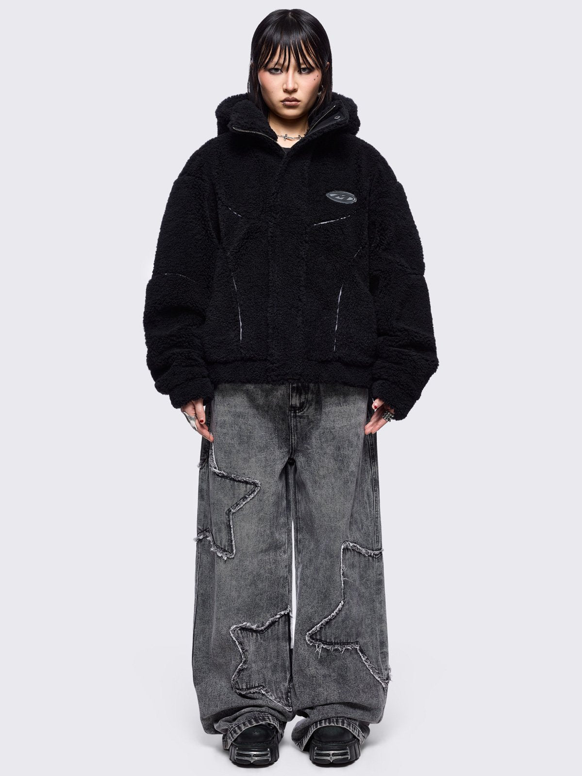 Black fleece hoodie jacket featuring grey piping and high neck hood.