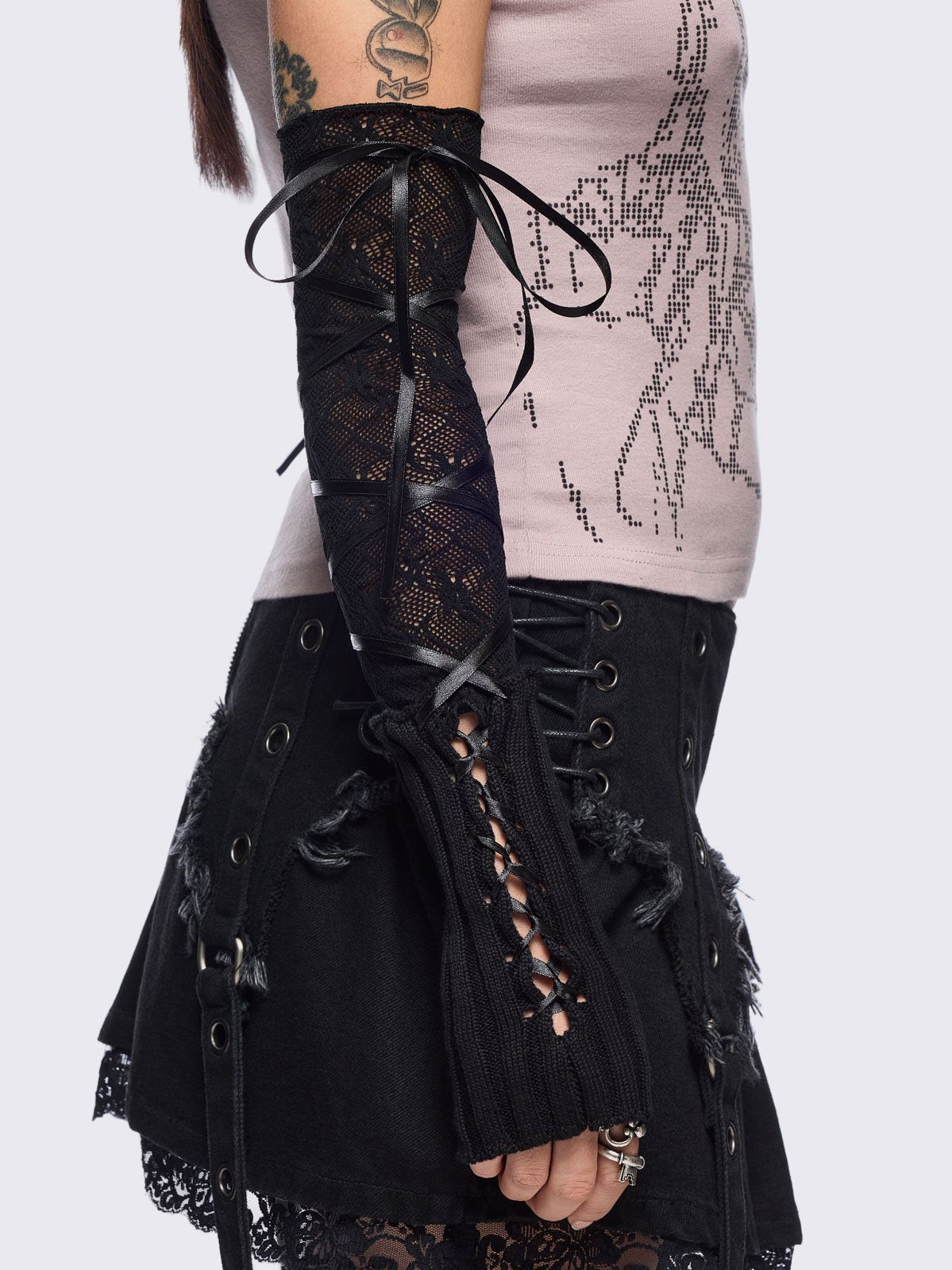 Black knit arm warmers featuring fishnet layer and lace up details.