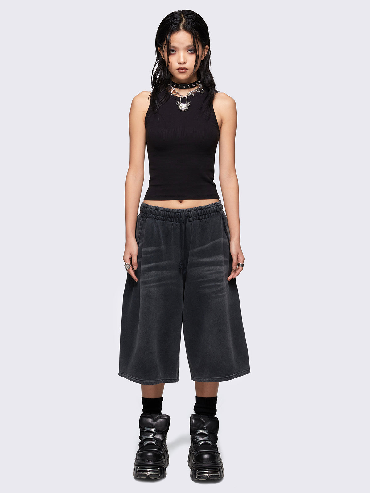 Black washed longline sweat shorts with signature embroidered back pocket detail, elasticated drawstring waist and oversized fit. 