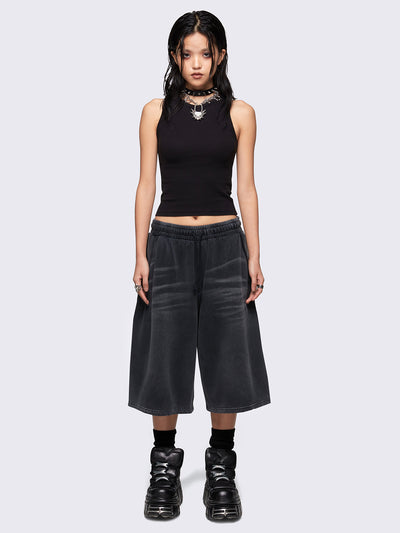 Black washed longline sweat shorts with signature embroidered back pocket detail, elasticated drawstring waist and oversized fit. 