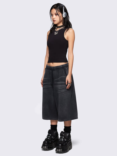 Black washed longline sweat shorts with signature embroidered back pocket detail, elasticated drawstring waist and oversized fit. 