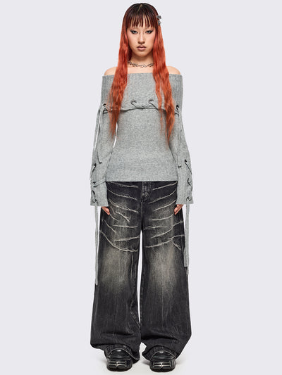 Grey off-shoulder knitted sweater with lace up details.
