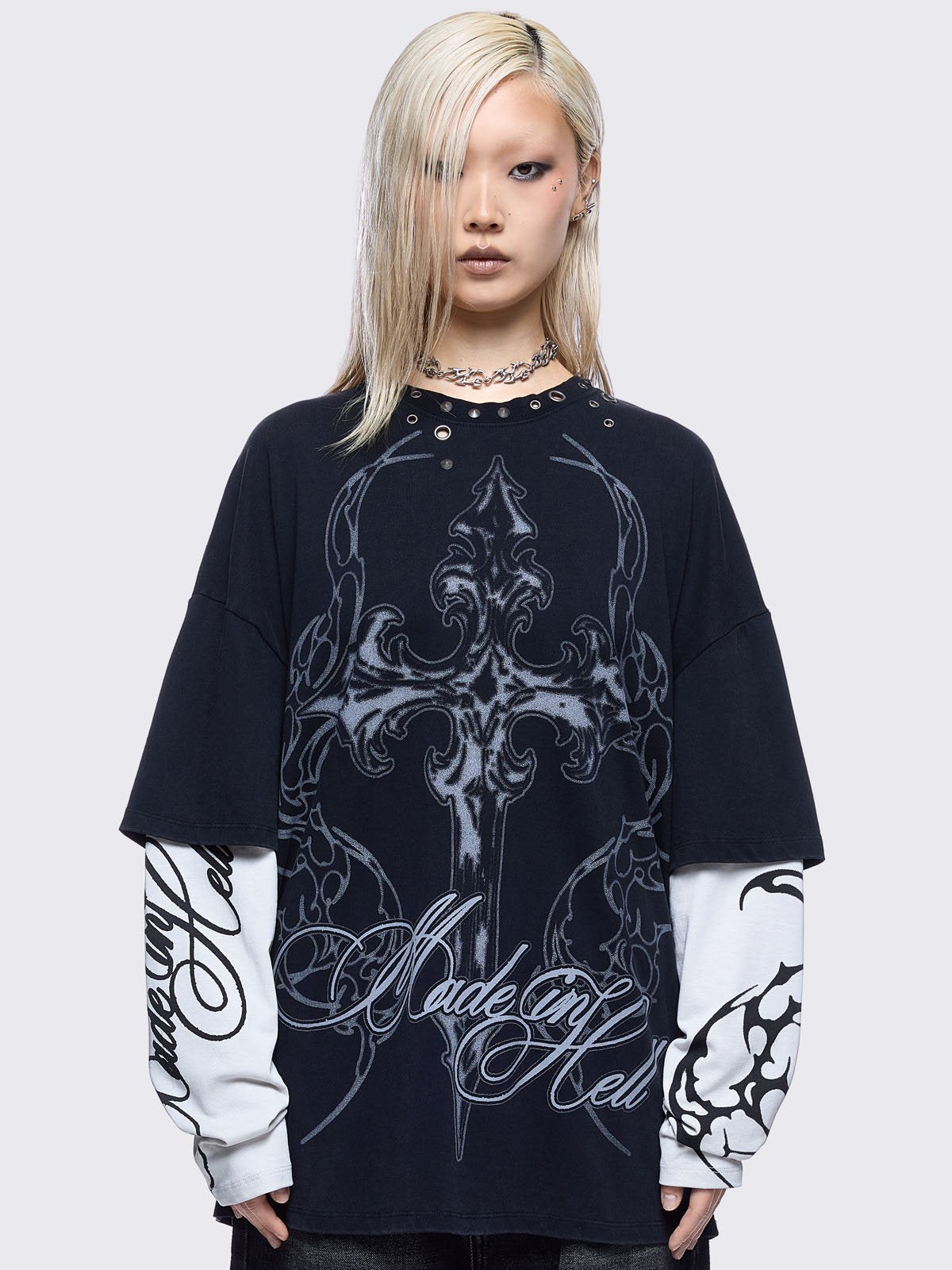 Black washed layered long sleeve t-shirt featuring "Made in hell" and cross graphic print, contrast off-white sleeves with sigilism print and silver eyelet and spike details.
