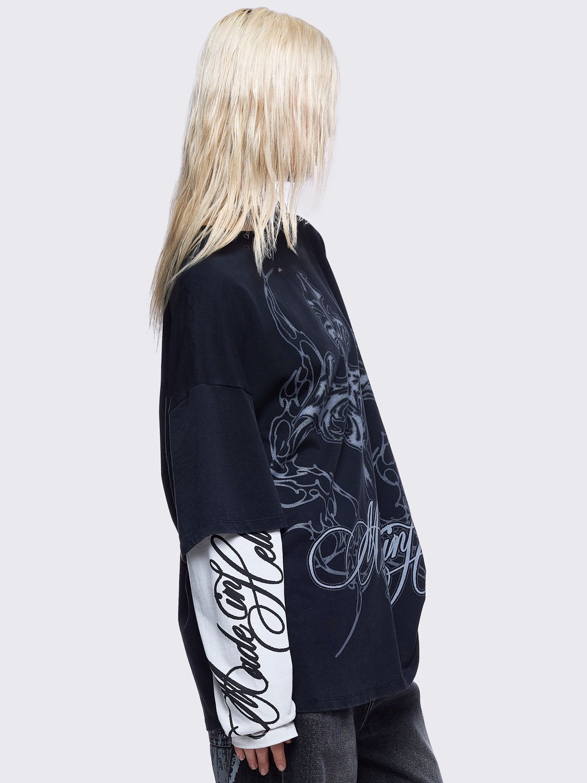 Black washed layered long sleeve t-shirt featuring "Made in hell" and cross graphic print, contrast off-white sleeves with sigilism print and silver eyelet and spike details.