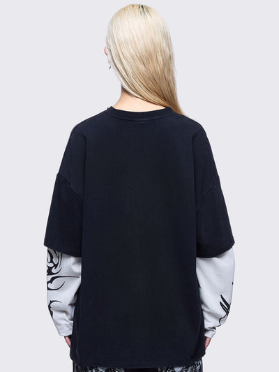 Black washed layered long sleeve t-shirt featuring "Made in hell" and cross graphic print, contrast off-white sleeves with sigilism print and silver eyelet and spike details.