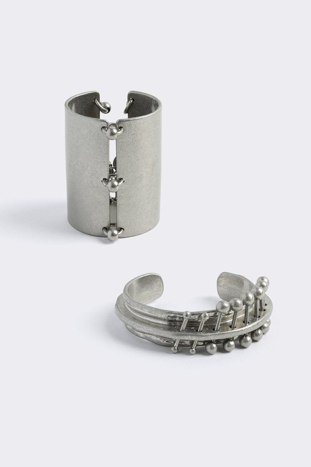 Set of 2 cuff bracelets with piercing details.