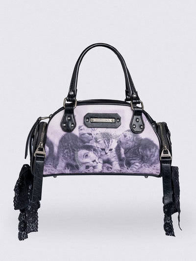 Black and pink bowling bag with kittens graphic print, rhinestone details and side exterior pockets with lace up bows.