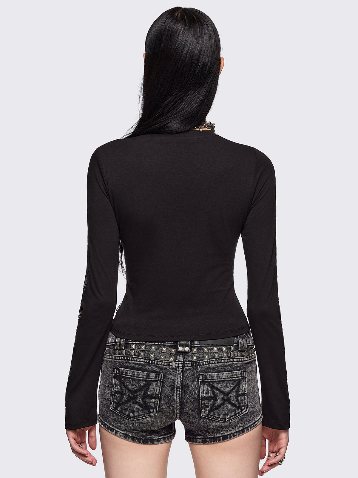 Black cut-out top with chunky silver eyelets.