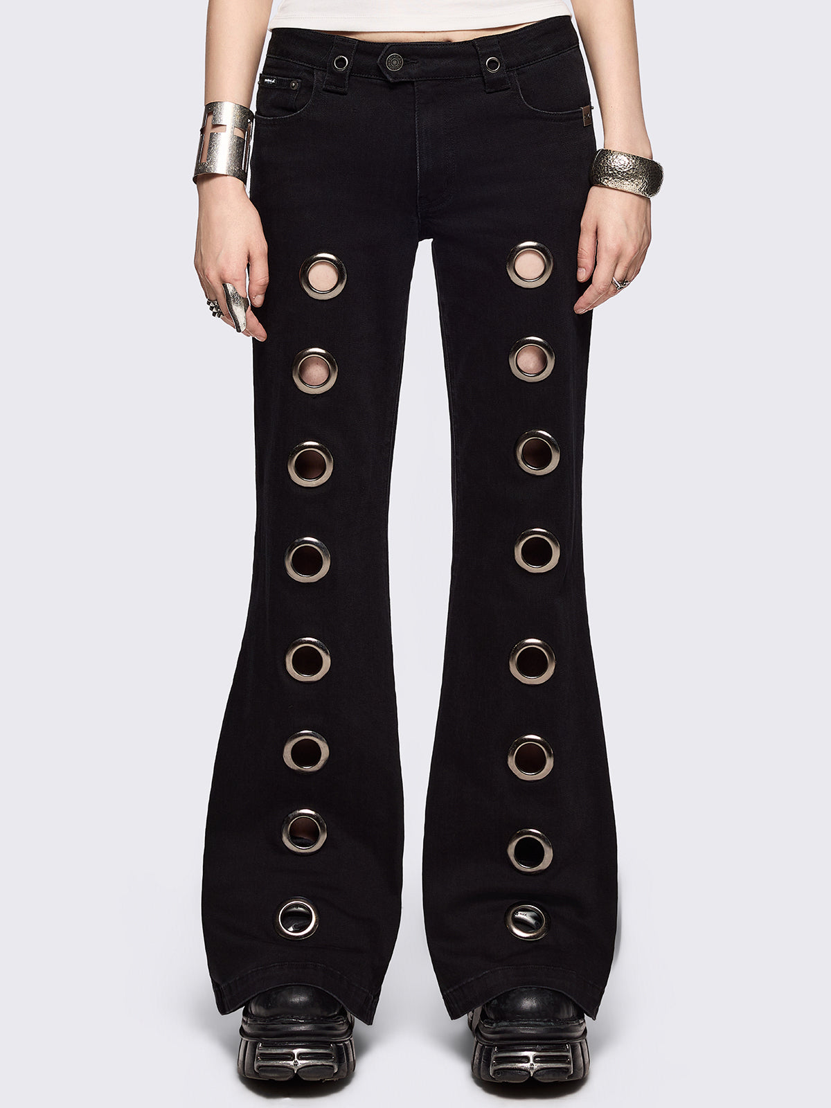Black flared jeans with chunky silver eyelets.