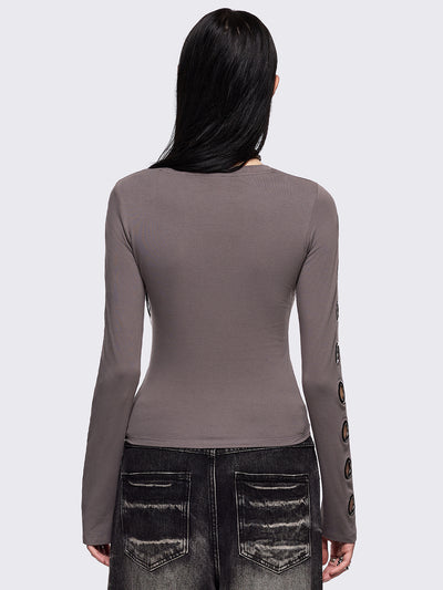 Grey cut-out long sleeve top with chunky silver eyelets on sleeves.