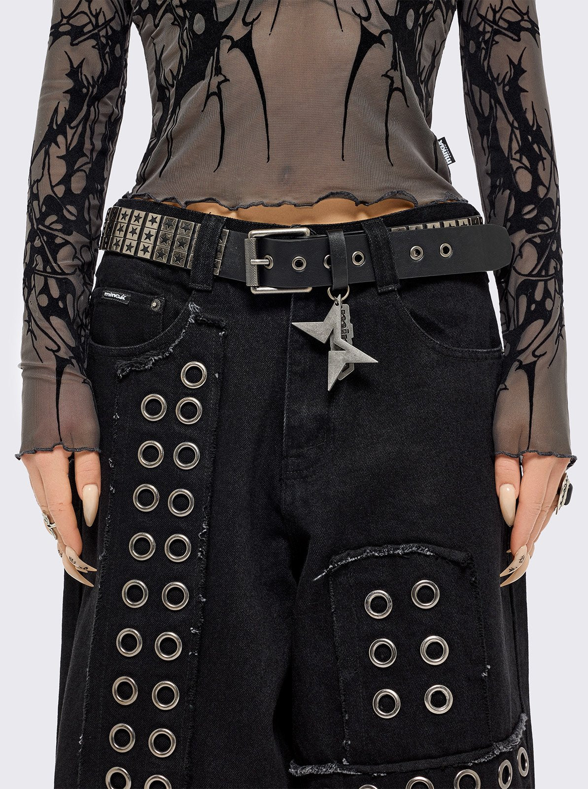 Black vegan leather buckle belt with silver studs in star design. 