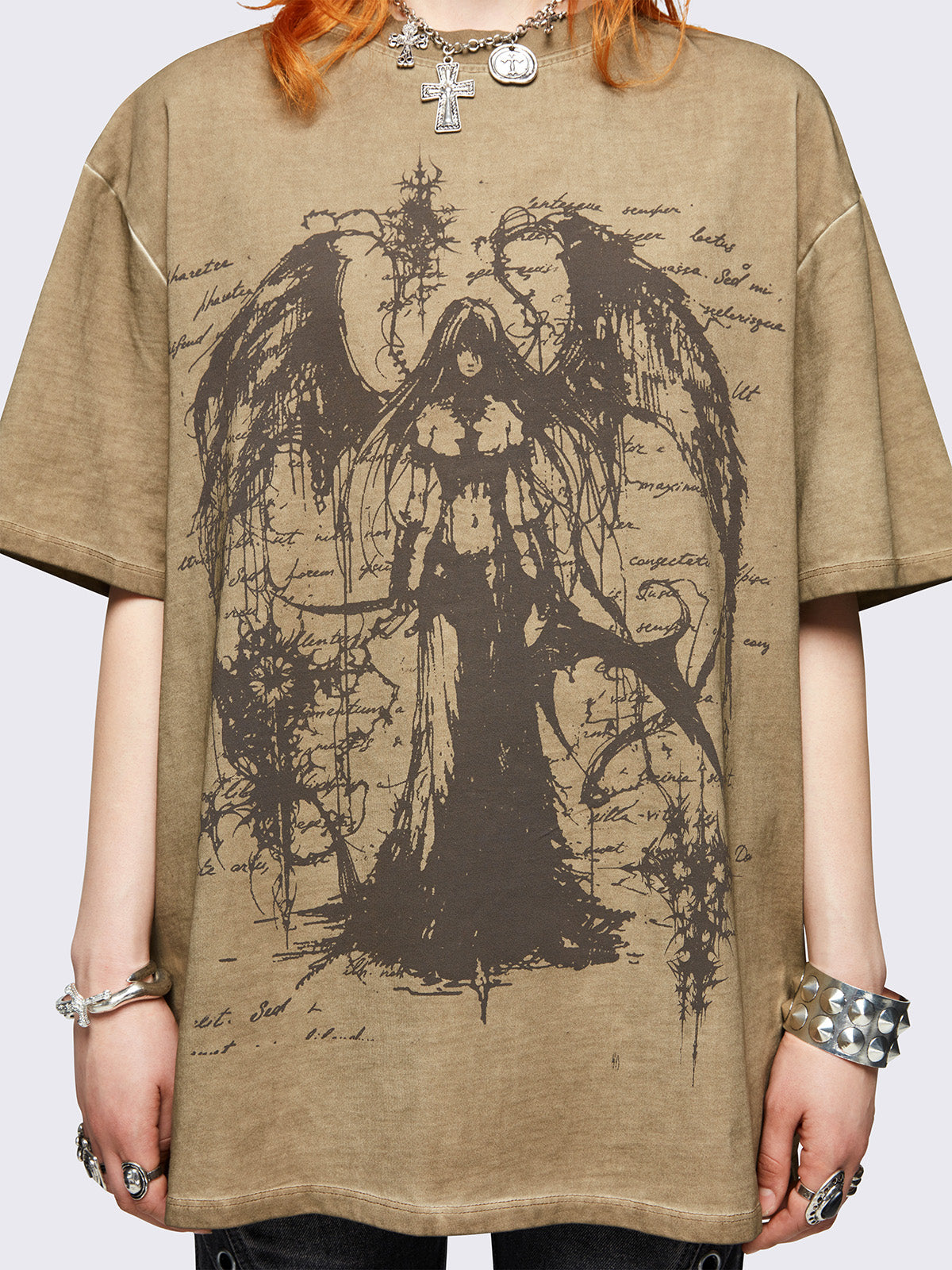 Brown washed oversized t-shirt featuring dark angel graphic front print.