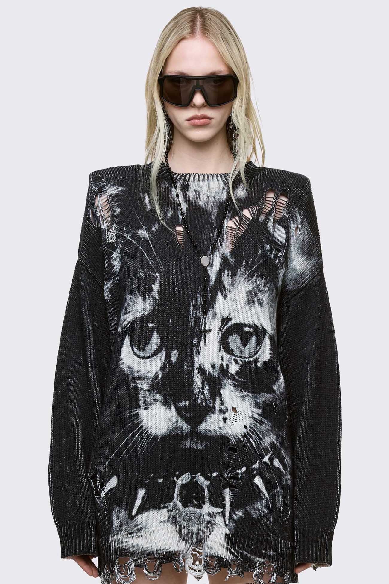Oversized longline black knit sweater featuring a large white cat graphic and heavy deconstructed shredding throughout the body.