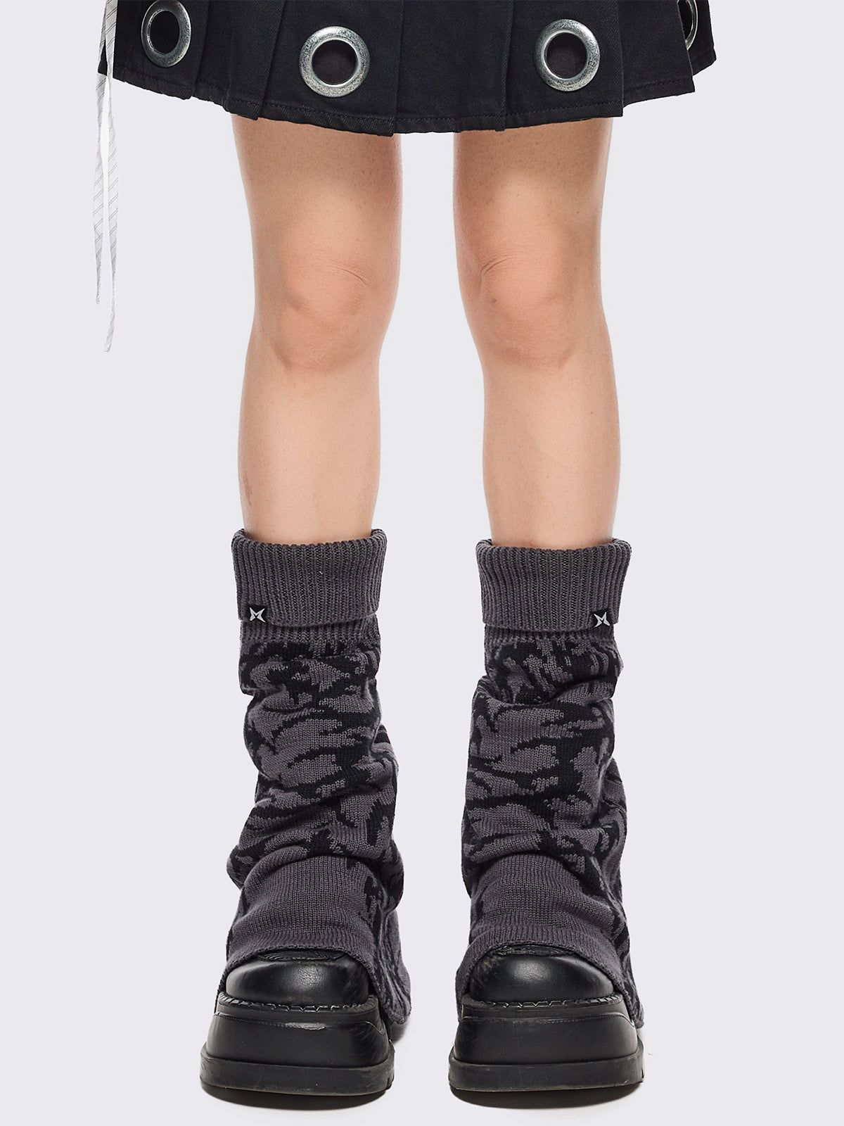 Grey flared leg warmers with black sigilism graphic design.