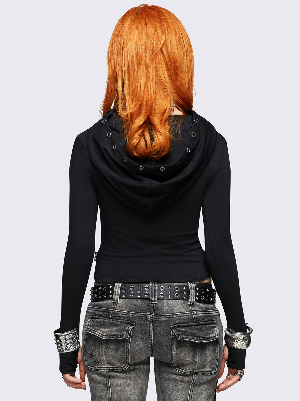 Black hooded top featuring a cowl neck with eyelets details, wings graphic front print and thumbhole cuffs. 