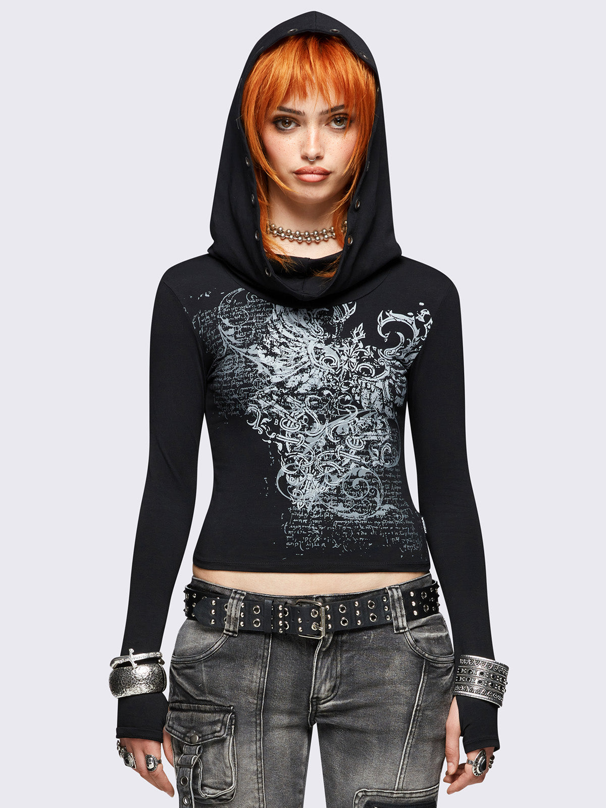 Black hooded top featuring a cowl neck with eyelets details, wings graphic front print and thumbhole cuffs. 