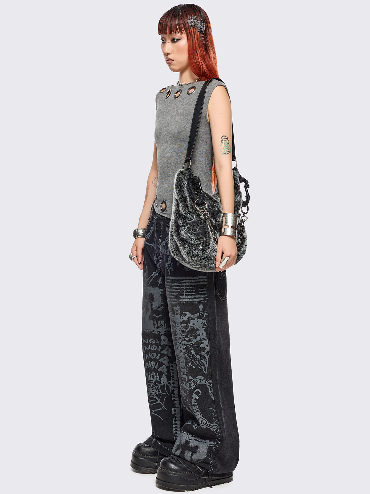 Black baggy wide leg jeans featuring a multi grunge graphic prints with white contrast stitching.