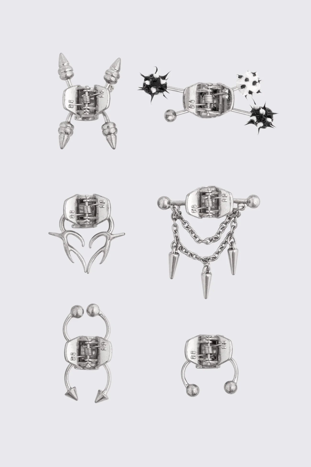 Mini claw hair clips in antique silver metal with spike, chain and sigil details in a cyber sigilism style.