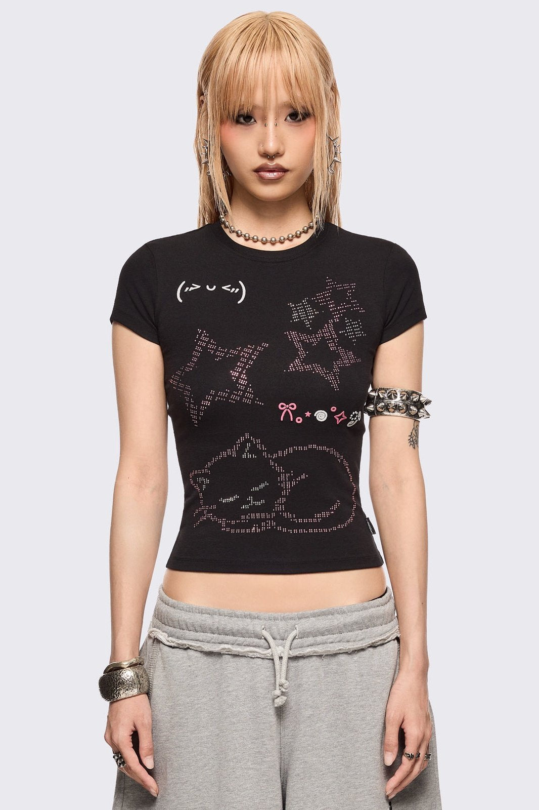 Black baby tee with kitty and stars graphic with stud and embroidery details.