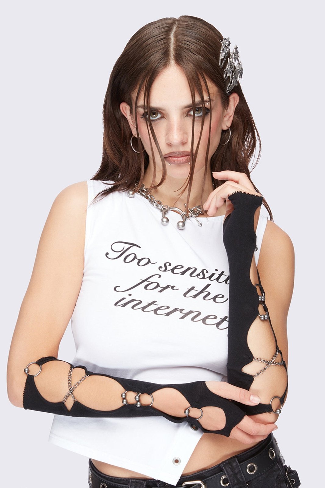 Black cut-out arm warmers with piercing and chain details.