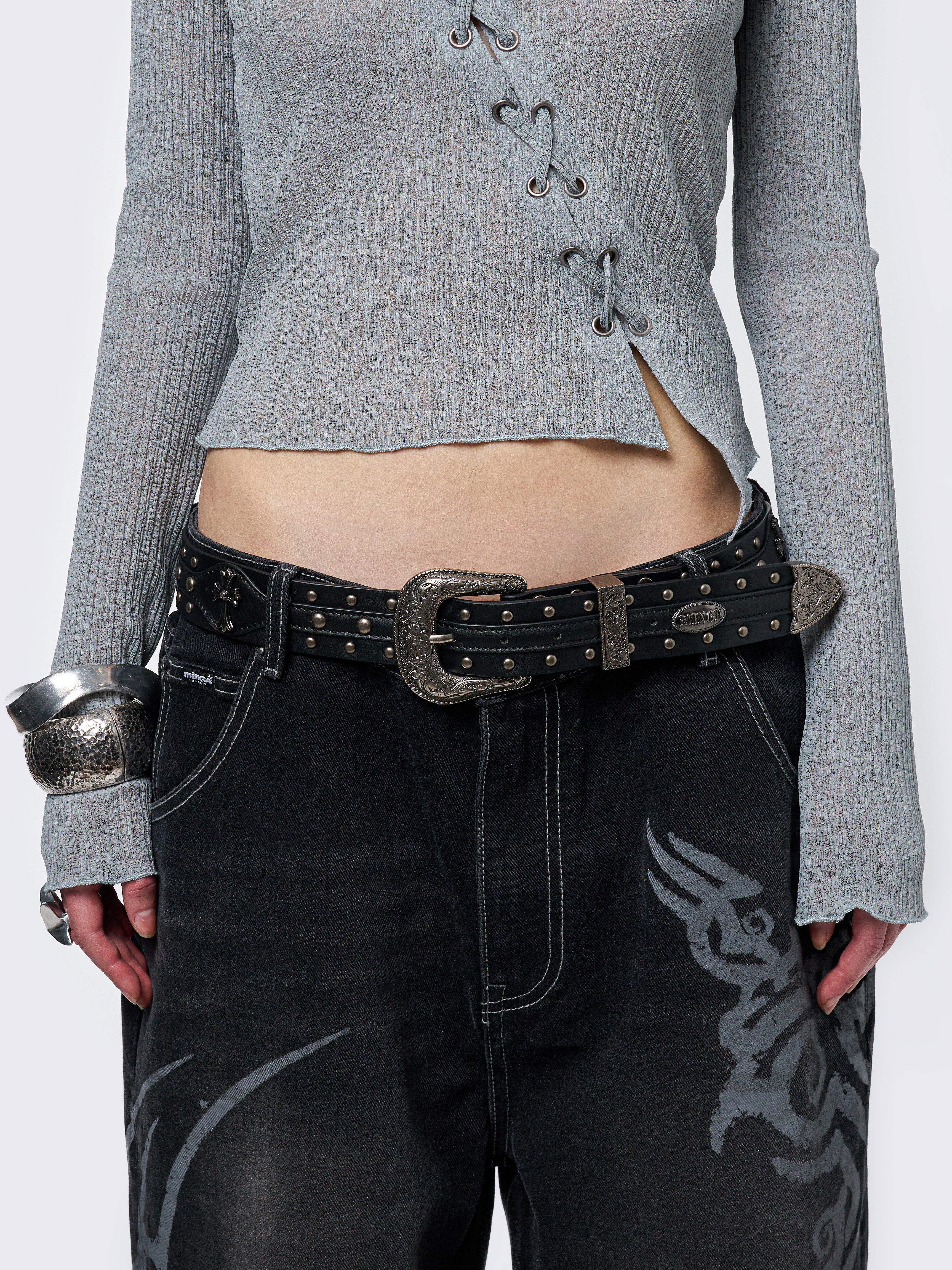 Black studded belt with an antique silver western-style buckle.