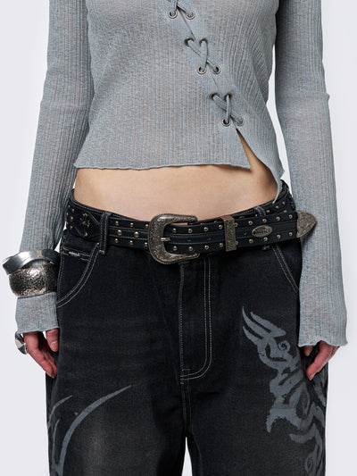 Black studded belt with an antique silver western-style buckle.